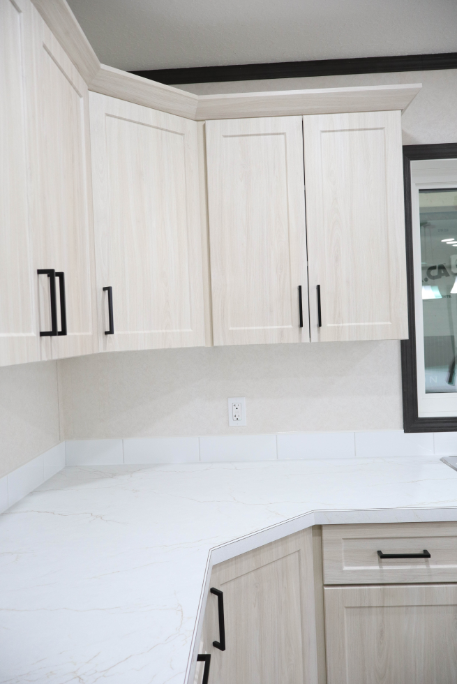 Custom white kitchen cabinetry in modular home